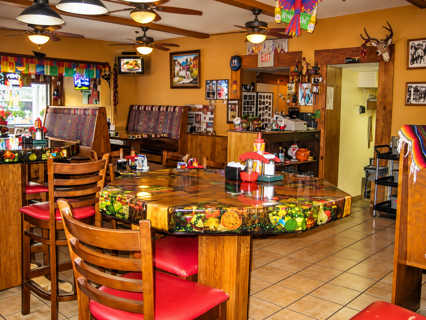 Colorful restaurant dining room with wooden tables and red chairs